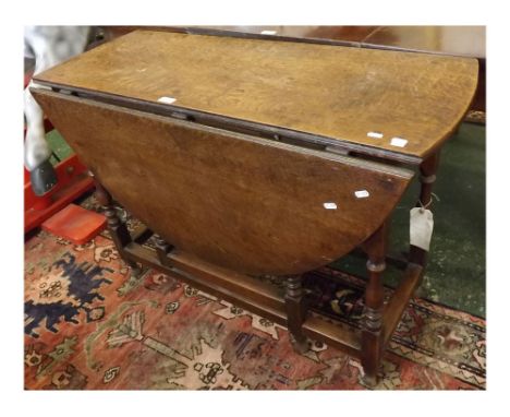 18th/19th century oval oak gate leg dining table on turned and blocked supports to a stretcher base, top 41ins x 50ins (when 