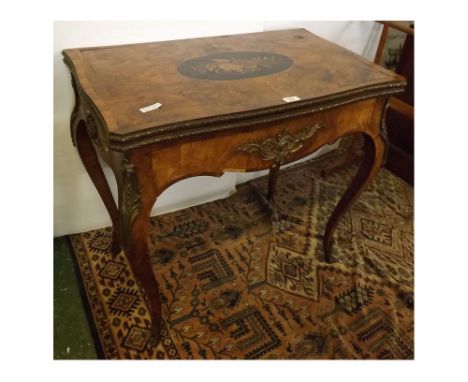 19th century French walnut flip-over card table with oval inset baize, decorative gilt mounts on cabriole legs, inlaid panel 