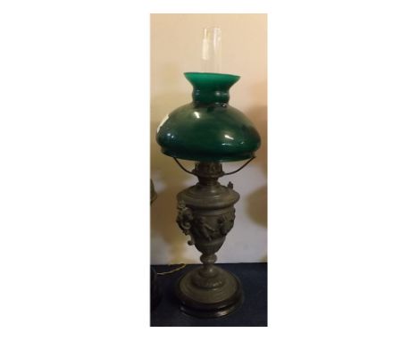 Metal cherub embossed and gilded oil lamp on a turned ebonised base, green shade, 22ins high  