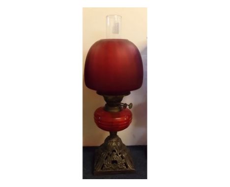 Victorian iron based oil lamp with ruby glass font, ruby shade, 21ins tall 