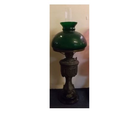 Victorian cast metal lamp on a black glass circular base with green shade, 22ins tall 