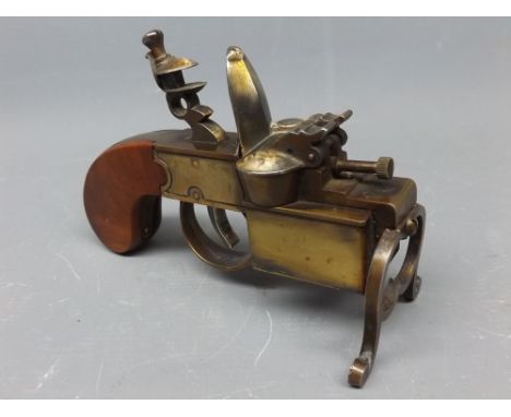 Brass and mahogany table lighter modelled as a flintlock pistol by Dunhill Tinder Pistol, pattern number 592139, 6ins long  