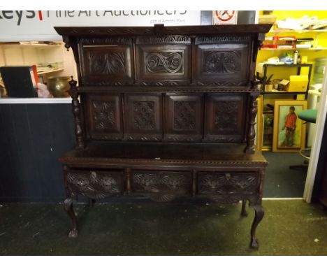 18th century and later oak carved dresser, with panelled back and single shelf, base with three drawers, raised on short cabr