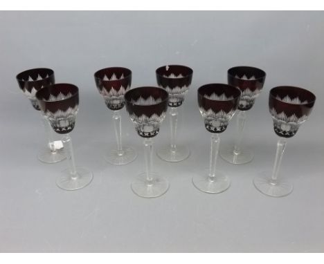 Set of eight ruby flash cut wine glasses with clear stems and circular bases, chips throughout, 8ins tall 