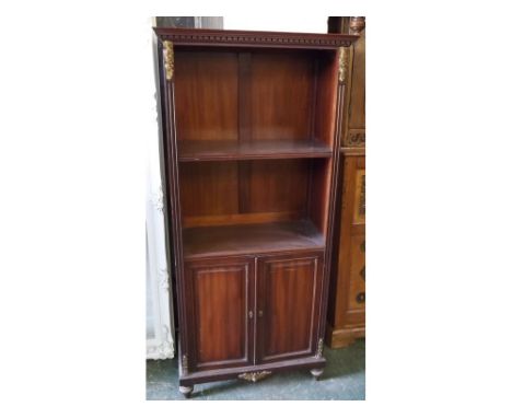 20th century mahogany bookcase with single fixed shelf over two panelled cupboard doors with gilt mounts and castellations to