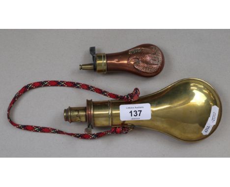 A vintage copper and brass colt pistol powder flask featuring an embossed eagle together with an antique stamped G &amp; JW H
