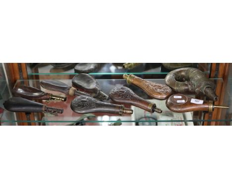 Collection of antique leather shot/powder pouches (4), brass powder flasks (4), and 1 brass Islamic shot/powder flask