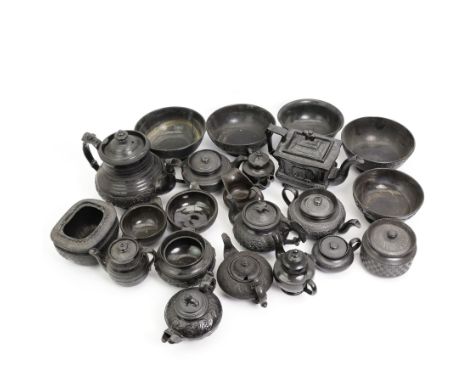 Early 19th century and later black basalt tea wares, mostly with relief or engine-turned bodies, including a Cyples square se