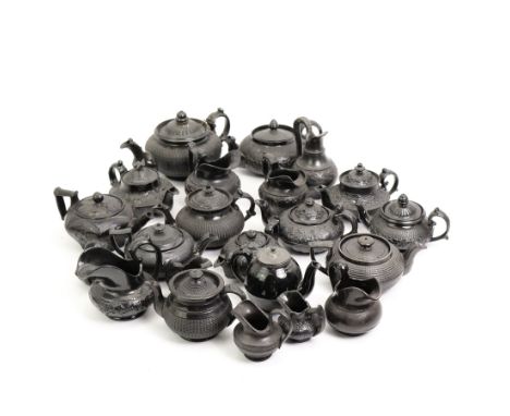 Early 19th century and later black basalt tea wares and similar stoneware, mostly with relief or engine turned bodies, includ
