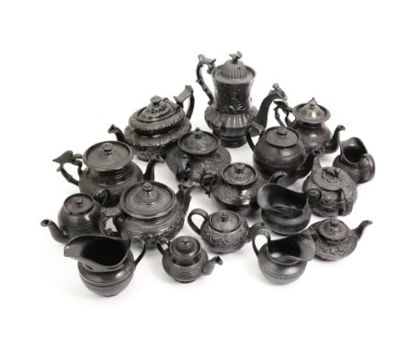 Early 19th century and later black basalt tea wares, mostly with relief or engine-turned bodies, including a Cyples bachelors