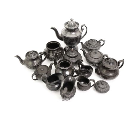 Early 19th century and later black basalt tea wares and similar stoneware, mostly with relief or engine-turned bodies, includ