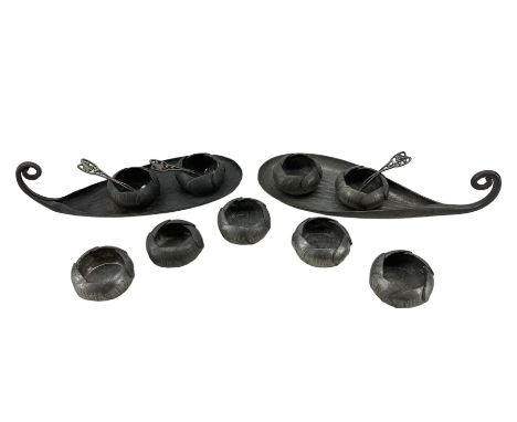 Nine French Art Nouveau pewter open salts, three salt spoons and two naturalistic leaf-shaped trays, by Alice & Eugene Chanal