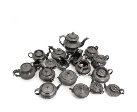 Early 19th century and later black basalt tea wares, mostly with relief or engine-turned bodies, including a Cyples bachelors