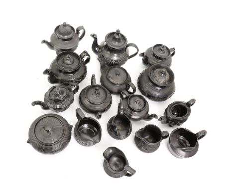 Early 19th century and later black basalt tea wares, mostly with relief or engine-turned bodies, including Cyples teapot, bac