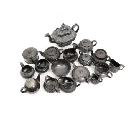 Early 19th century and later black basalt tea wares and similar stoneware, mostly with relief or engine-turned bodies, includ
