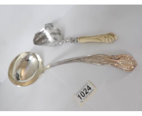 An ornate silver plated crumb scoop and a silver plate ladle