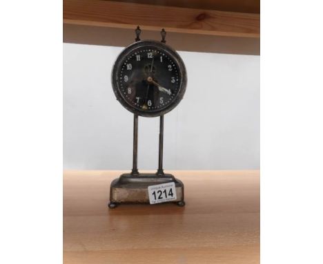 An unusual metal cased mantel clock