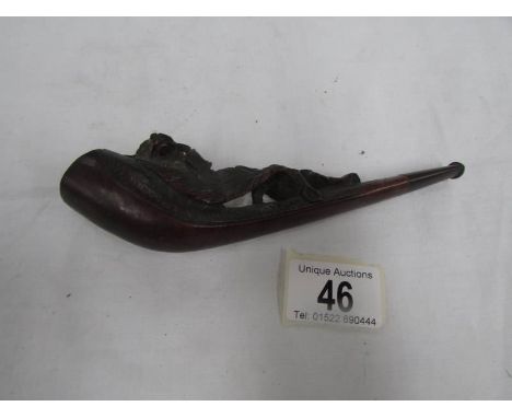 A Black Forest pipe with dog ornamentation