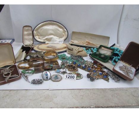 A mixed lot of vintage jewellery including necklaces, brooches, bangles etc and a pair of opera glasses