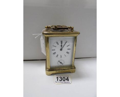 A French brass carriage clock with key and alarm