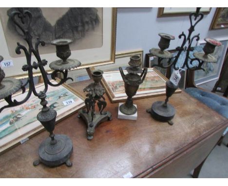 A pair of candelabra and 2 other candlesticks