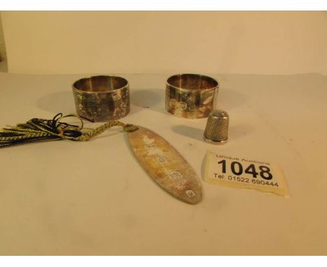 2 silver napkin rings, a silver pendant and one other silver item