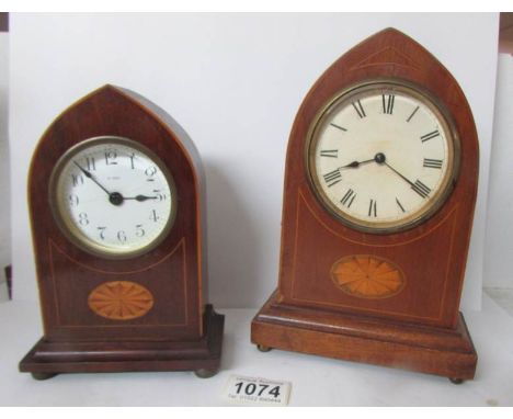 An arched top mantel clock with shell inlay and a smaller example