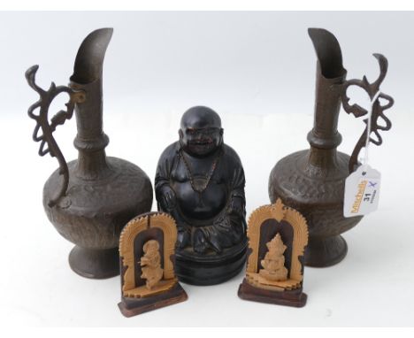 Pair of metal vases depicting Indian style hunting scenes, 21 cm high, Buddha ornament and two small wooden deities 