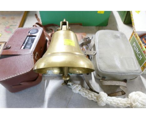 Brass bell mounted on a hardwood plaque, Kodak movie camera and an Agfa Movestar camera
