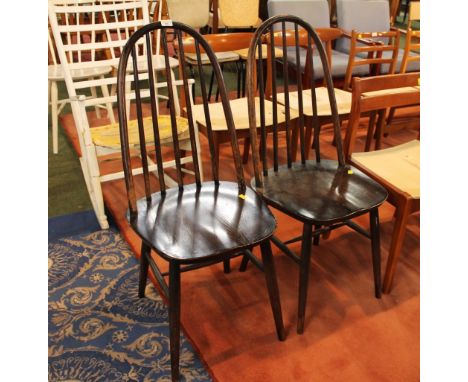 Two dark stained Ercol style spindle back chairs