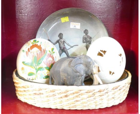 Royal Doulton plate Aborigines with hunting weapons, two decorated ostrich eggs, wooden carved elephant and glass dish in wic