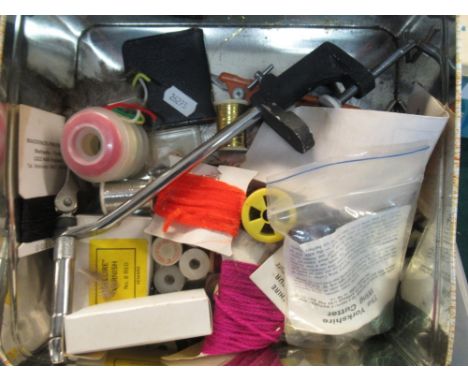 Two boxes of fly-tying equipment including various furs, feathers, wire and a bench top fly-tying vice 