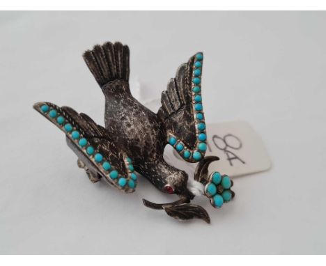 A attractive antique silver and turquoise dove of peace with a glass panel hair locket back with ruby eyes 