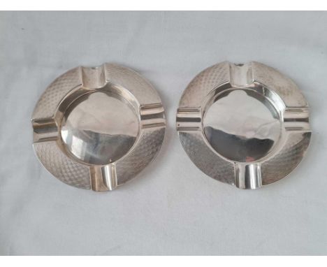 A pair of circular ashtrays with engine turned borders 3 1/2 inches wide B'ham 1926 - 76 gms 