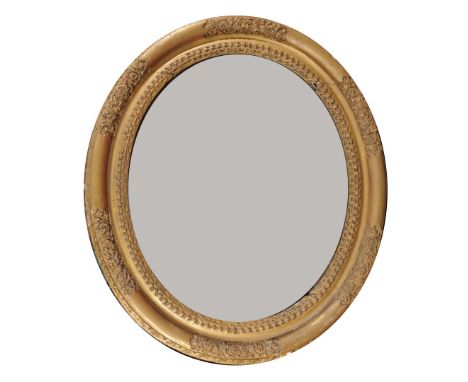 AN 18TH CENTURY CARVED GILTWOOD OVAL PORTRAIT FRAME, 95cm high overall, containing a late mirror plate