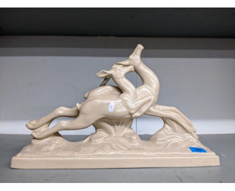 Charles Lemanceau (1905-1980) - a French Art Deco ceramic sculpture of two leaping deer in beige colourway, signed to base, f