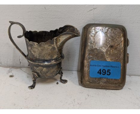 A late 19th/early 20th century silver engraved cigarette case 45.9g, and a silver cream jug 96g Location: 