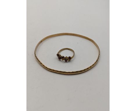 A yellow metal bangle, tested 14ct gold together with a 9ct gold ring total weight 9.8gLocation: 