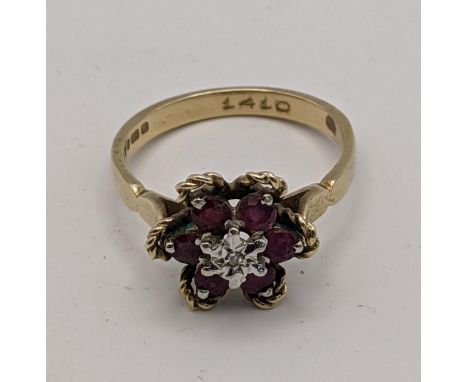 A 9ct gold ruby and diamond ring in the form of a flower, total weight 2.8g 