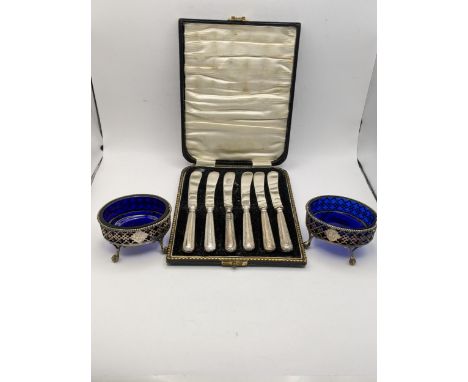 A pair of silver pierced salts together with a cased set of six silver handled butter knives.Location: 