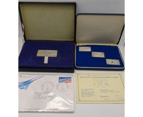 A cased set of three silver concord postage stamps, together with a certificate along with a Danbury mint 1976 first day cove