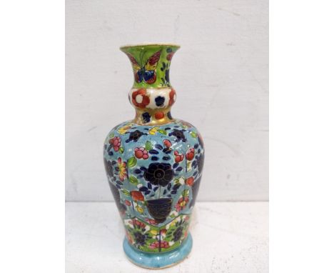 An 17th/18th century clobbered Chinese vase decorated with flowers Location: 