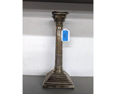 An early 20th century silver candlestick of ribbed design raised on square stepped base with gadrooning to the lower step, 25
