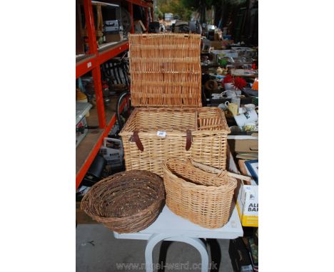 A wicker hamper (no contents), a bicycle basket and one other basket.