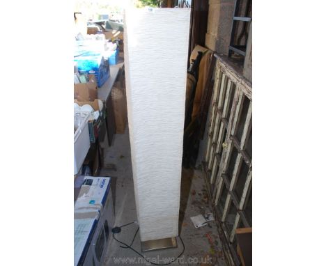 A floor lamp with a tall square shade.