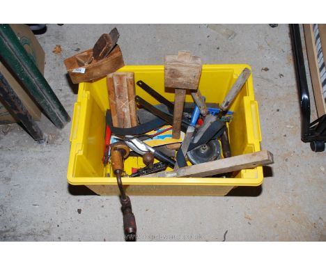 A tub of hand-tools including braces, a mallet, a block plane, a spirit level, etc.,