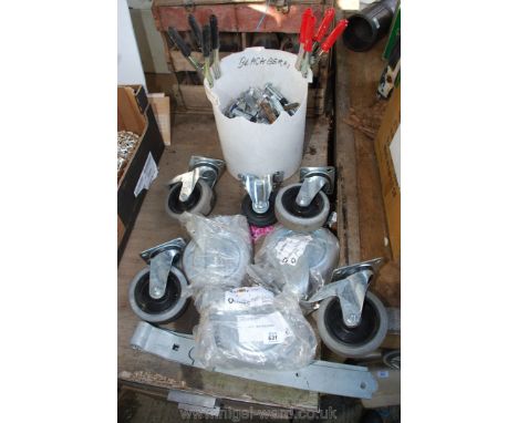A tub of rawl-bolts, trolley wheels, galvanised gate hinges, drill bits, etc.,