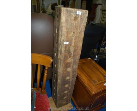 A heavy, drilled timber beam pillar wine bottle stand.