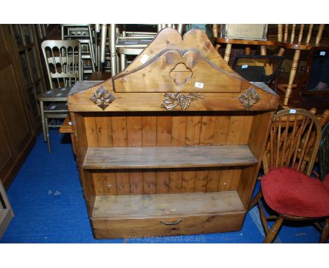 A Pine two shelf wall unit with drawer under and decorative frieze with fruiting vines in relief.