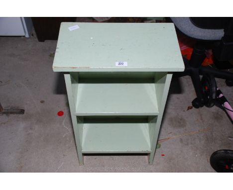 A wooden green painted two-shelf bookcase. 28'' high x 17'' wide x 10'' deep.